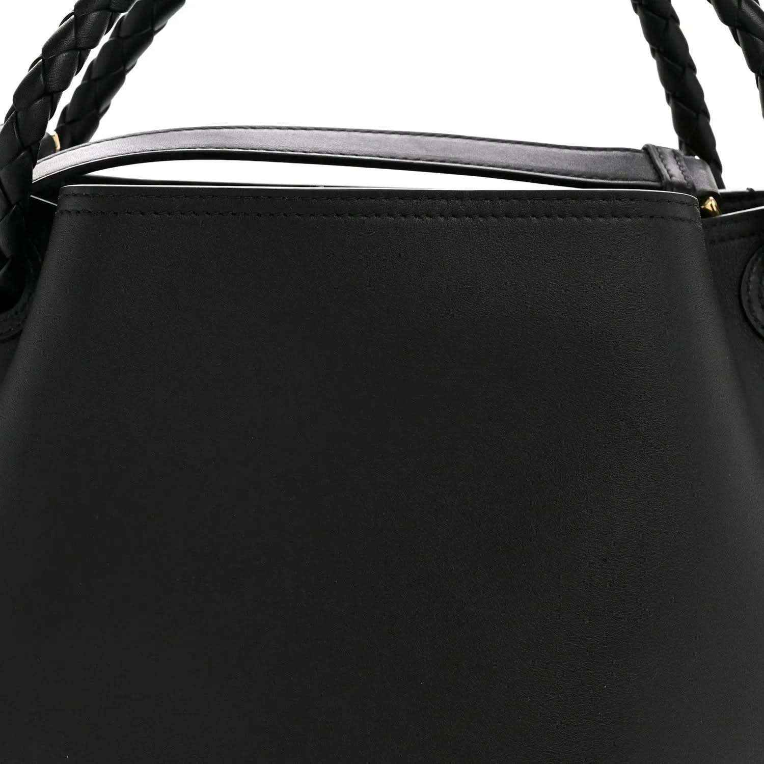 Black bucket bag top edge with braided handle and leather trim