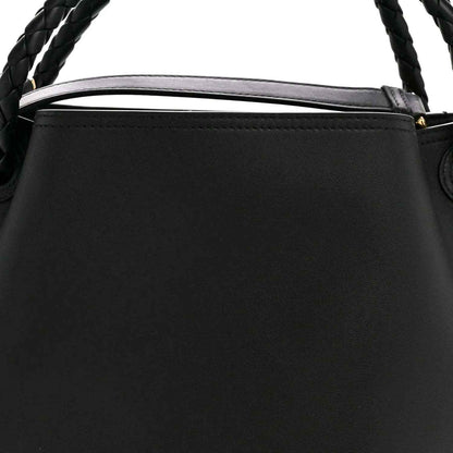 Black bucket bag top edge with braided handle and leather trim