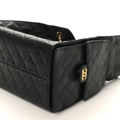 Black Chanel quilted leather handbag with gold-tone handle hardware and flap front, medium