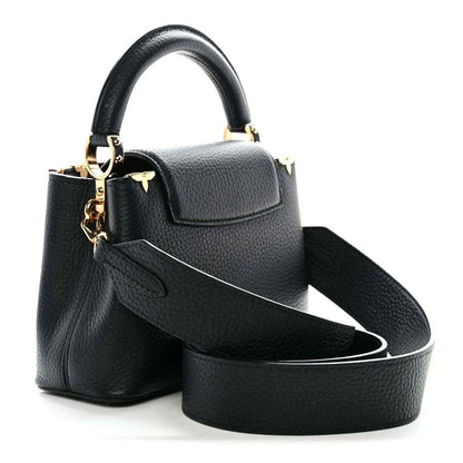Black mini handbag with flap front, gold LV charm, and detachable crossbody strap