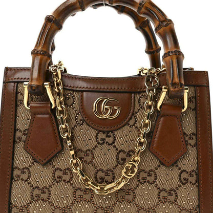 Gucci mini tote bag front, tan GG monogram canvas with brown leather pocket and gold chain