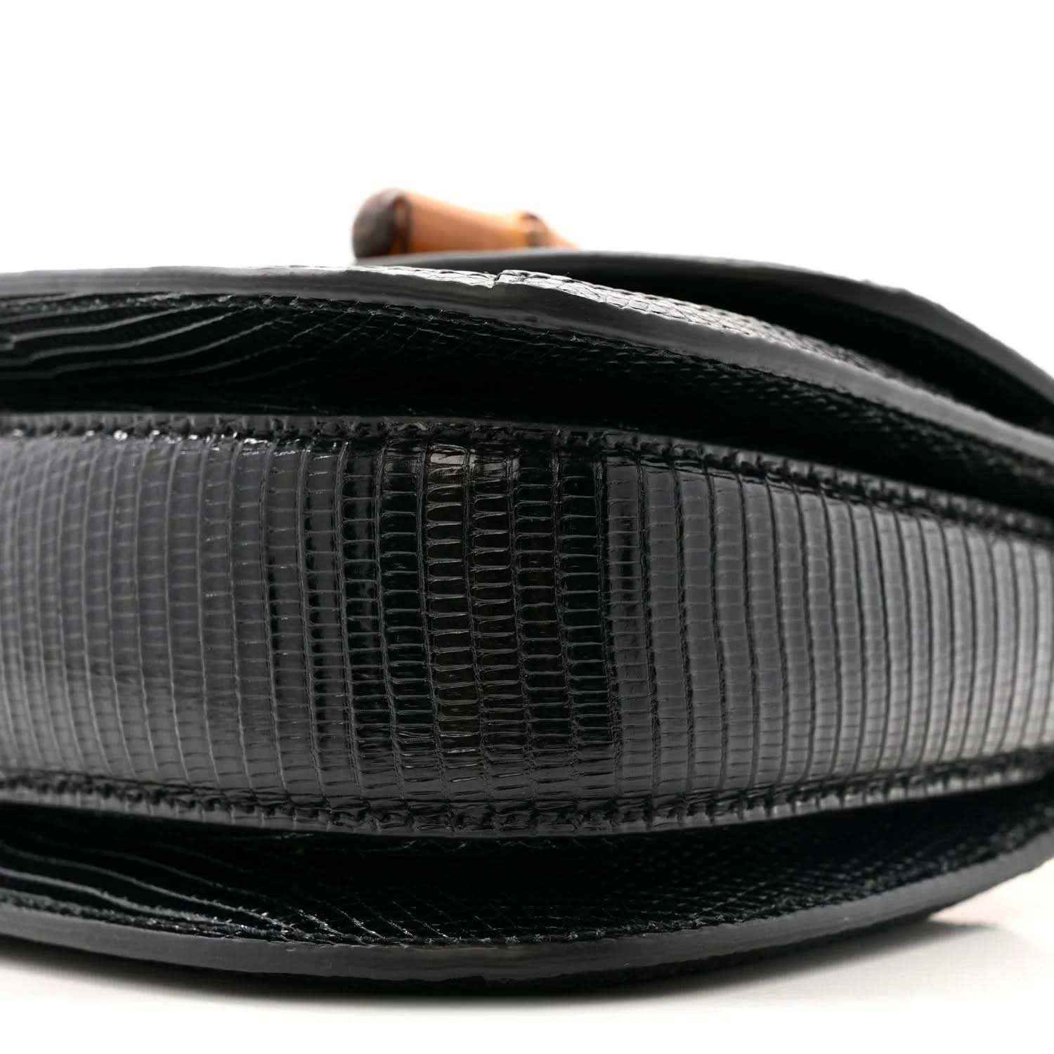 Close-up side of black mini bag exterior with textured panels and dark trim