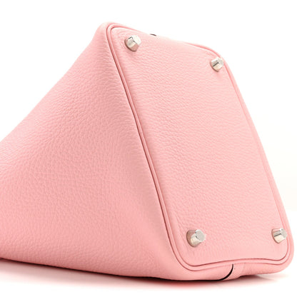Rose pink leather handbag with triangular fold and silver snap studs