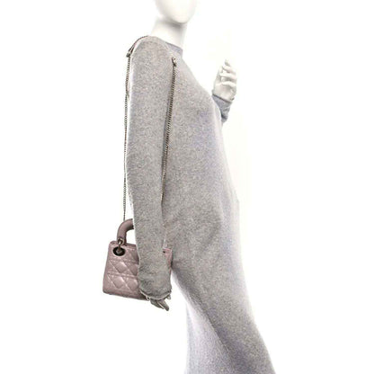 Mini Lady Dior handbag in rose pink lambskin, shown from the side with shoulder strap