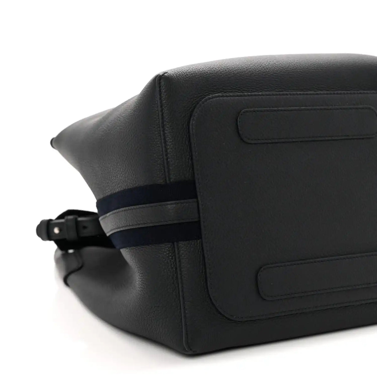 Dark navy leather bag exterior close-up with flap panel and adjustable belt strap