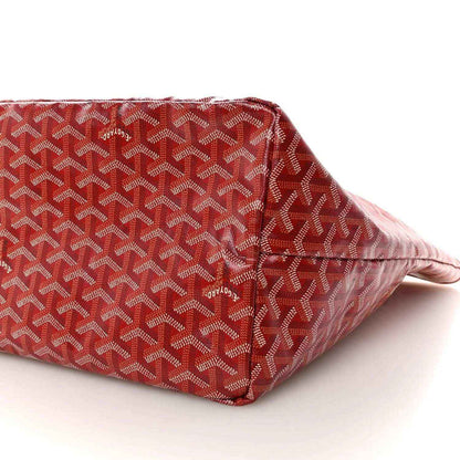 Red Goyardine canvas tote bag side panel with Goyard pattern and corner seam.