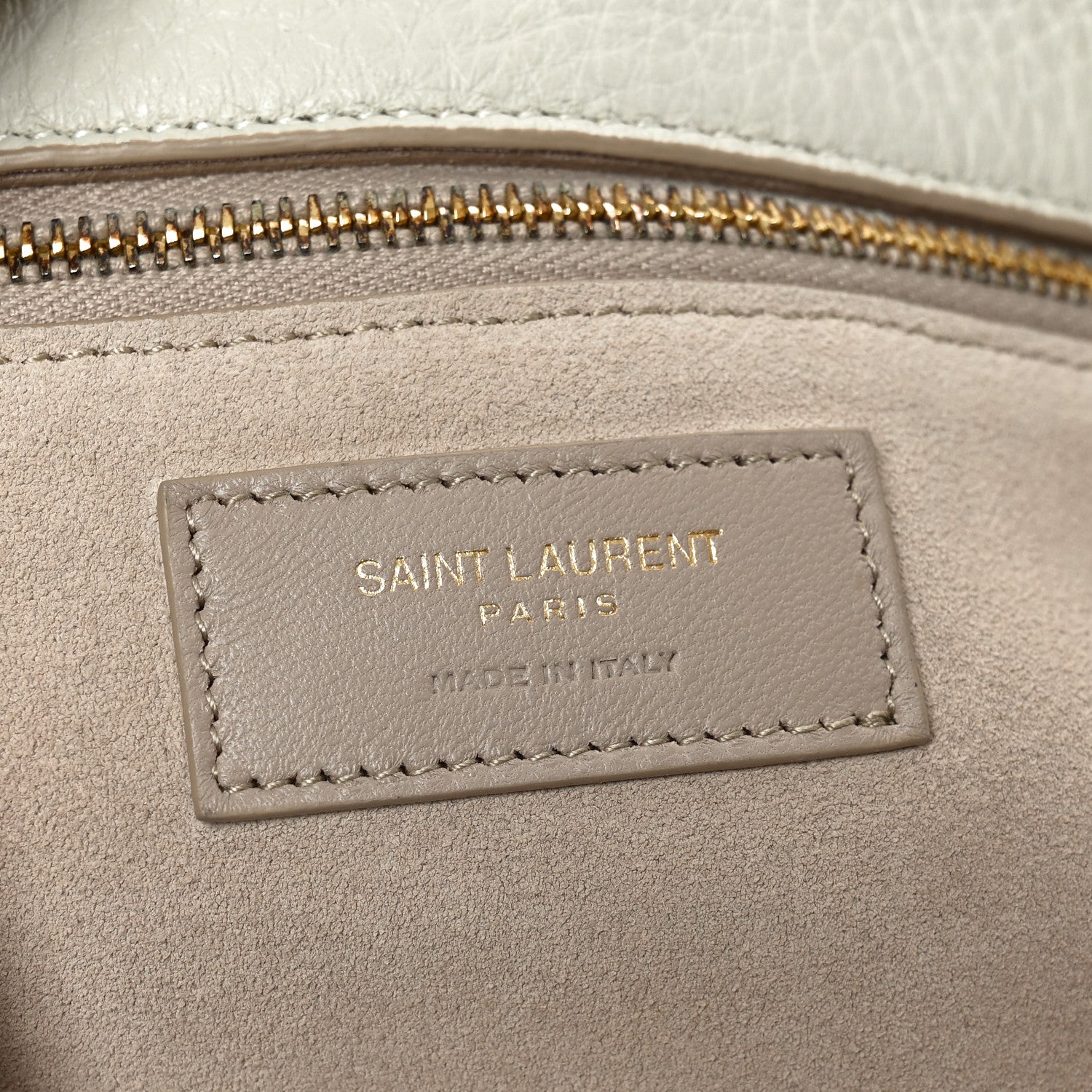 Tote bag interior label with stitched border near the zip opening