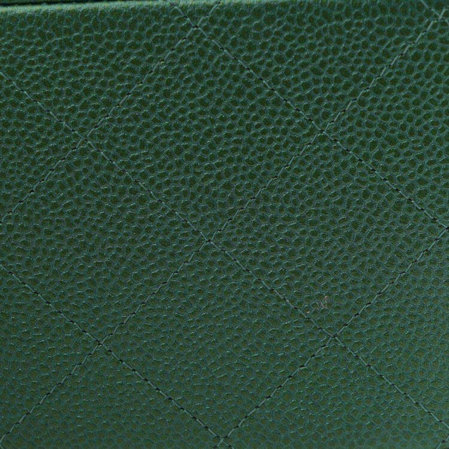 Green quilted caviar leather surface with diamond stitching texture.