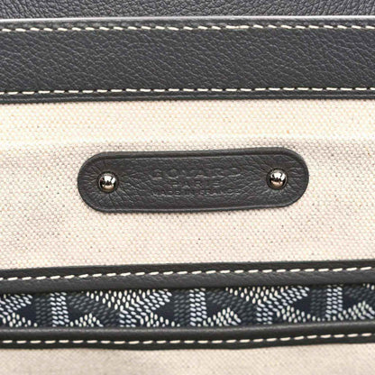 Leather tote pocket with embossed Goyardine mark and metal rivets, grey stitching