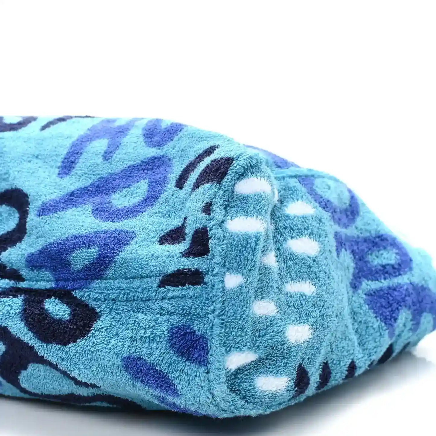 Turquoise terry tote end with black, white, and purple abstract animal graphic pattern.