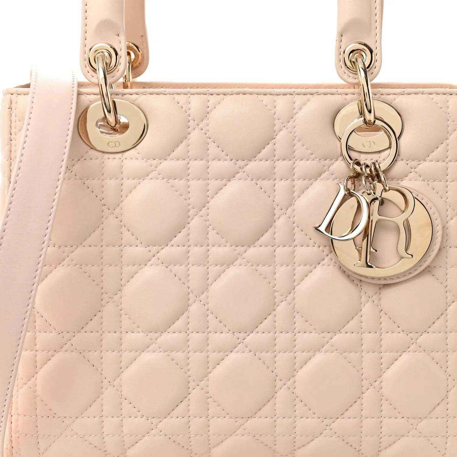 Powder pink quilted handbag front with gold-tone Dior charm and top zip hardware.