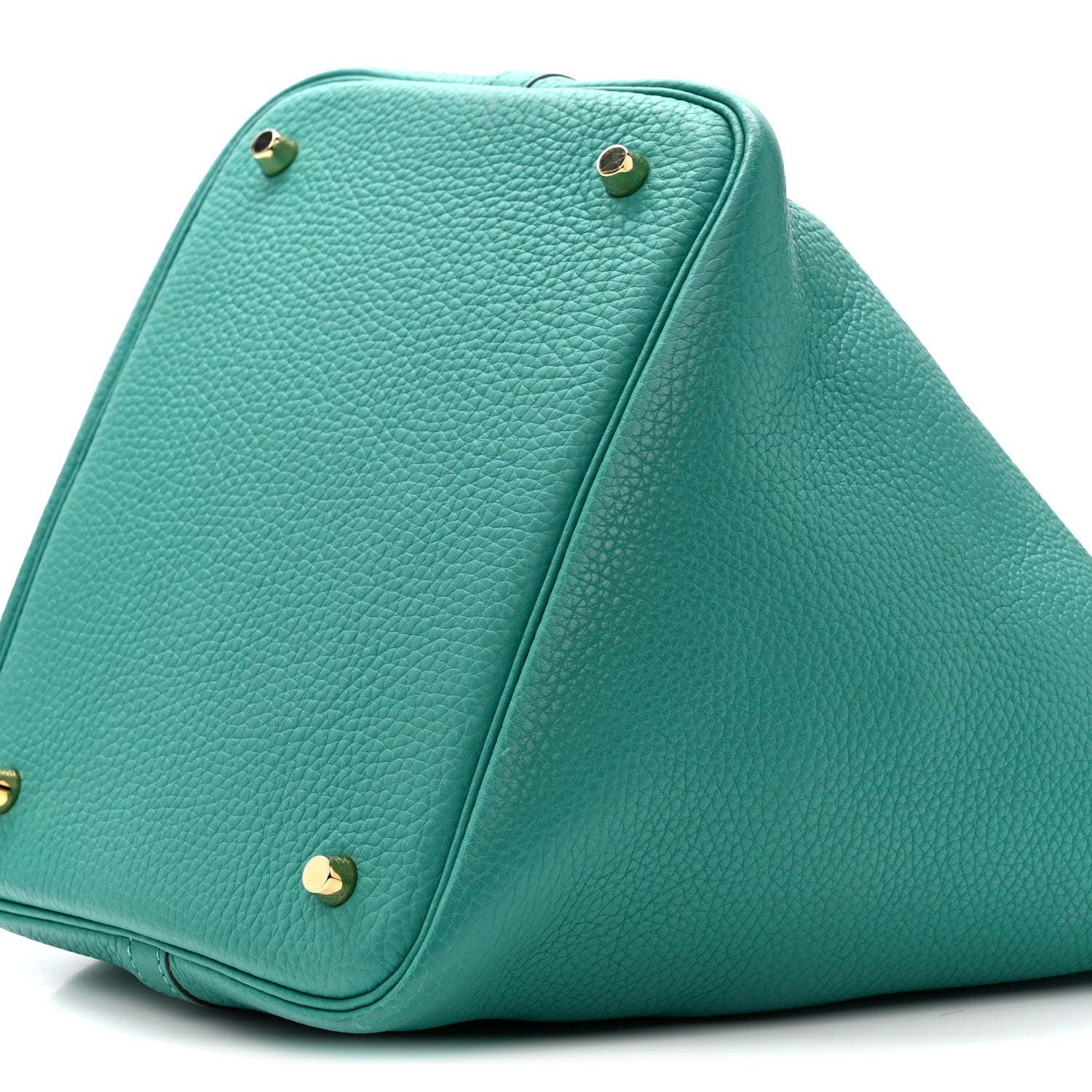 Green leather tote with structured triangular shape and gold-tone corner studs