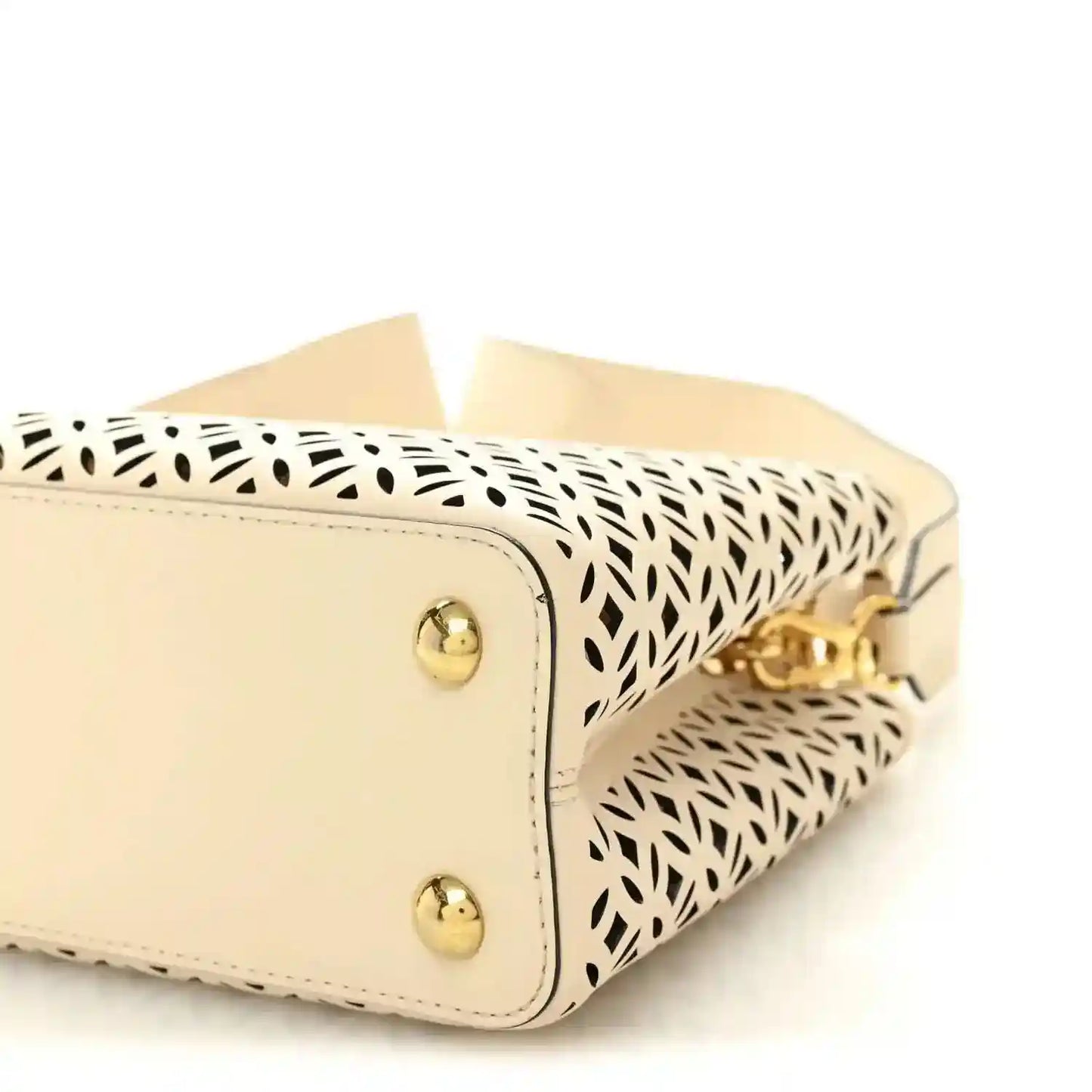 Louis Vuitton mini handbag close-up with two gold studs and patterned side panel