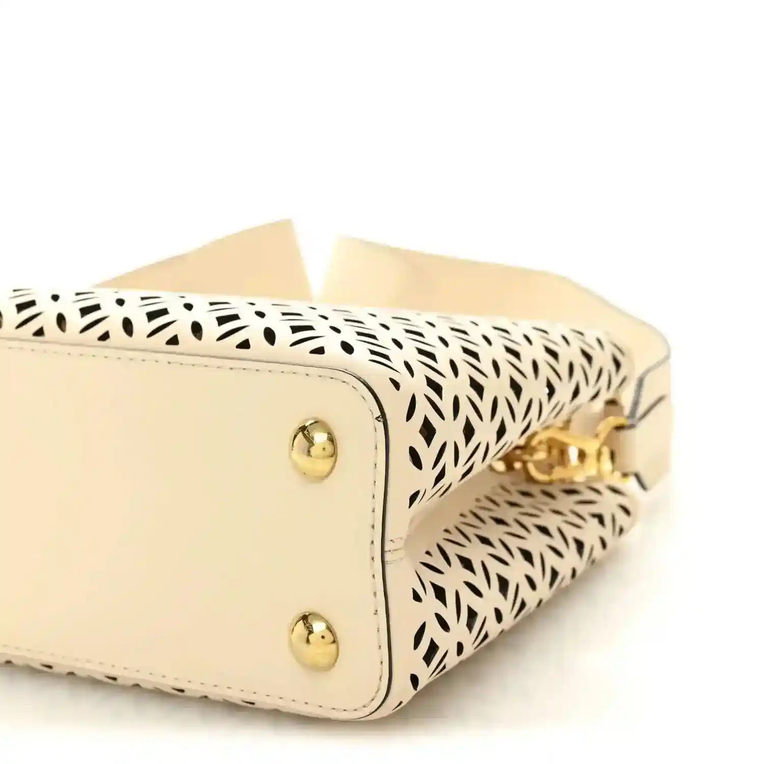 Louis Vuitton mini handbag close-up with two gold studs and patterned side panel