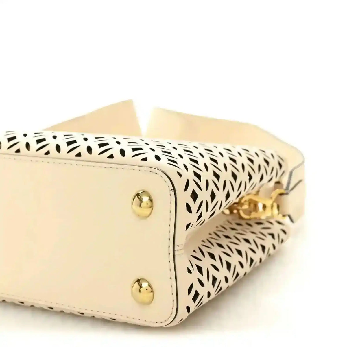 Louis Vuitton mini handbag close-up with two gold studs and patterned side panel