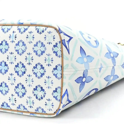 Louis Vuitton Neverfull blue patterned side panel with tan trim at the corner