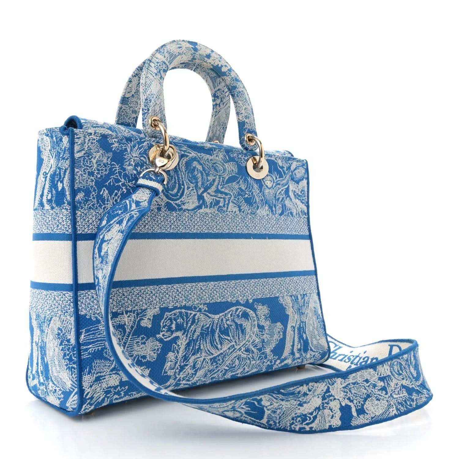 Blue embroidered handbag with top handles, gold hardware, and long strap attached.