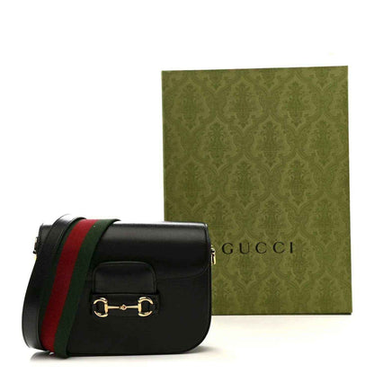 Black mini horsebit shoulder bag with red and green Web stripe strap, gold clasp