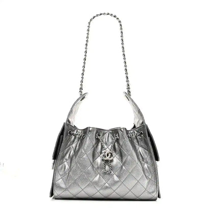 Chanel metallic caviar quilted small handbag with silver chain strap and drawstring closure