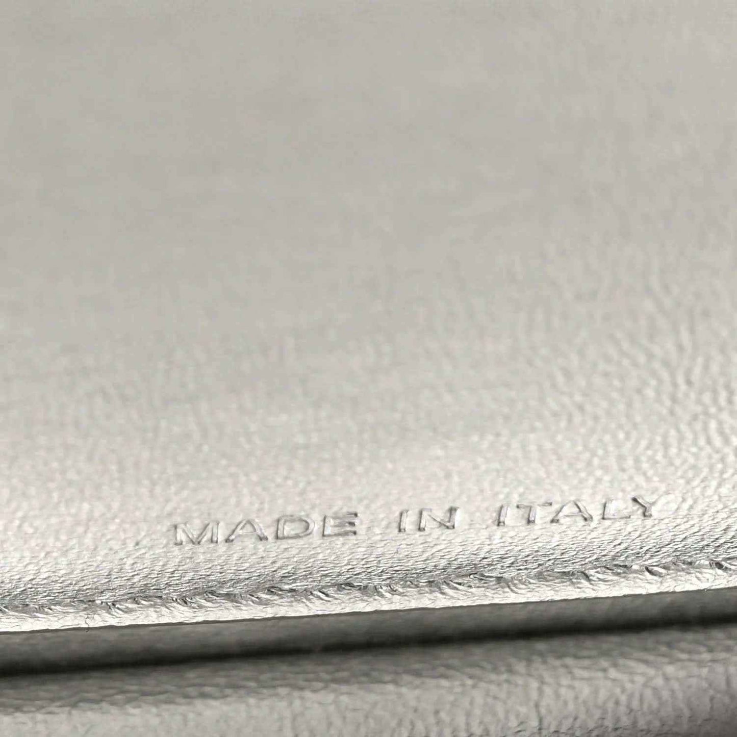 “MADE IN ITALY” embossing on interior leather lining, with stitched edge.
