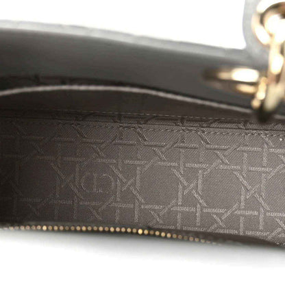 Grey jacquard-lined interior with gold zipper track and signature-style pattern