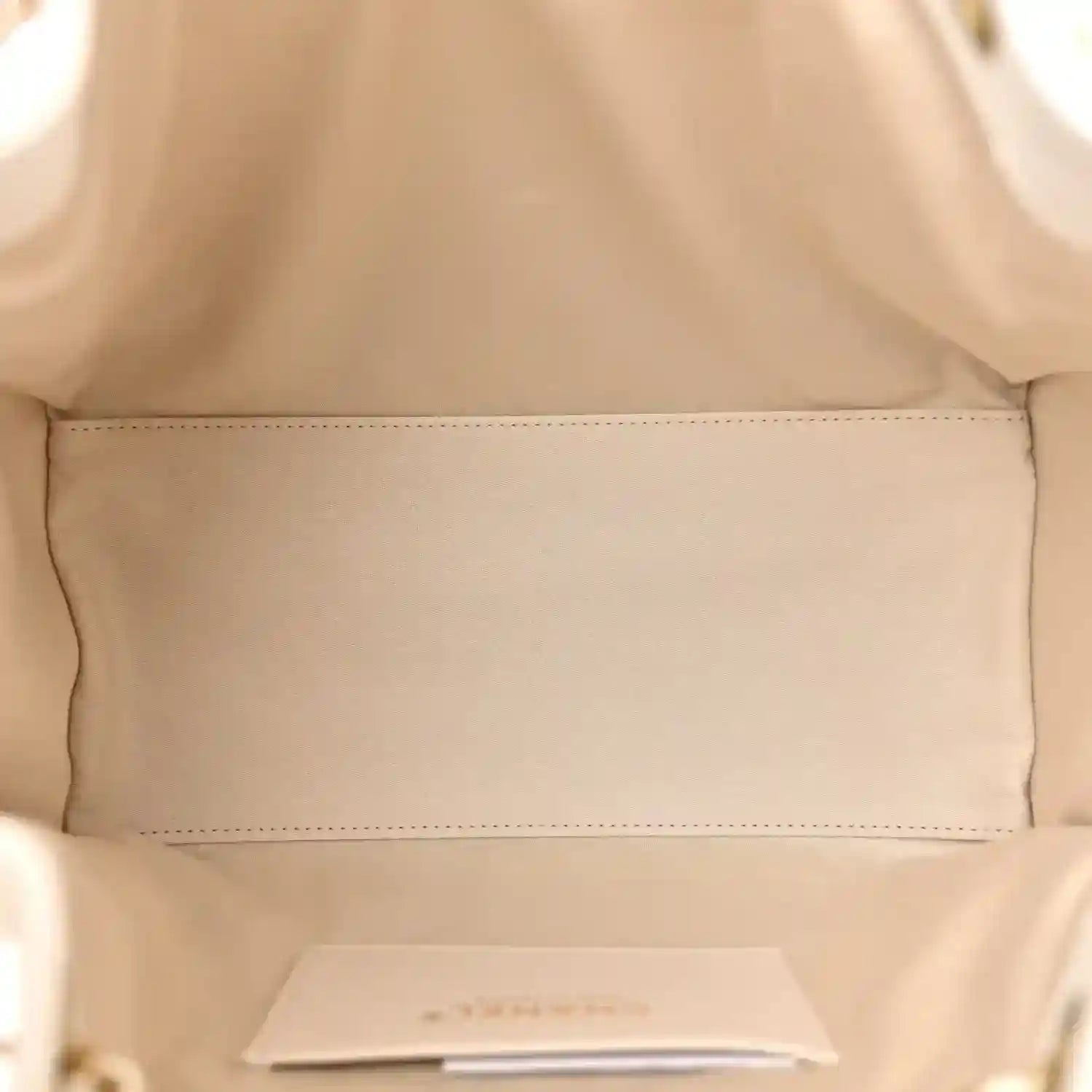 White quilted leather handbag interior with open lining pocket