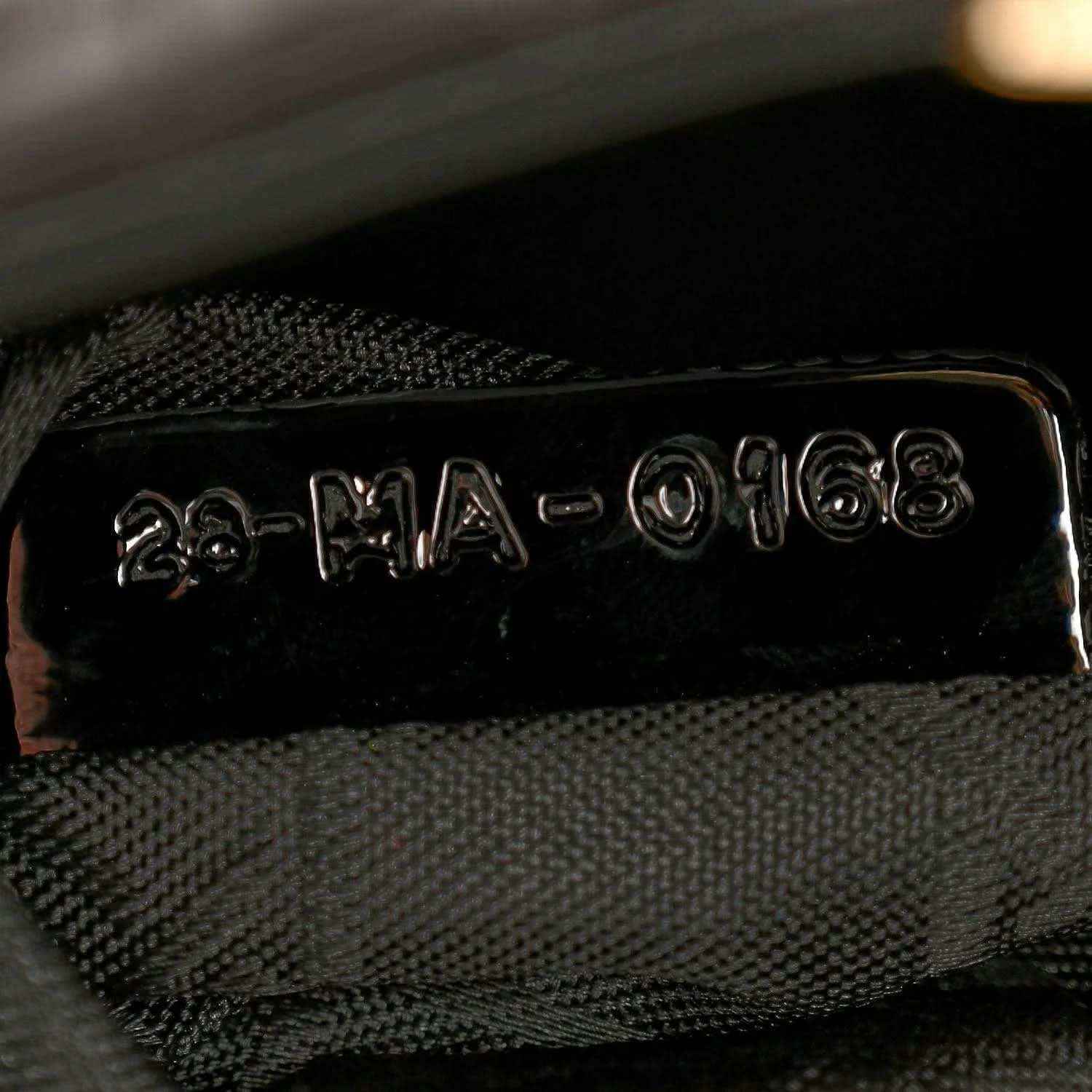 Black fabric lining with stitched label inside mini Lady Dior handbag