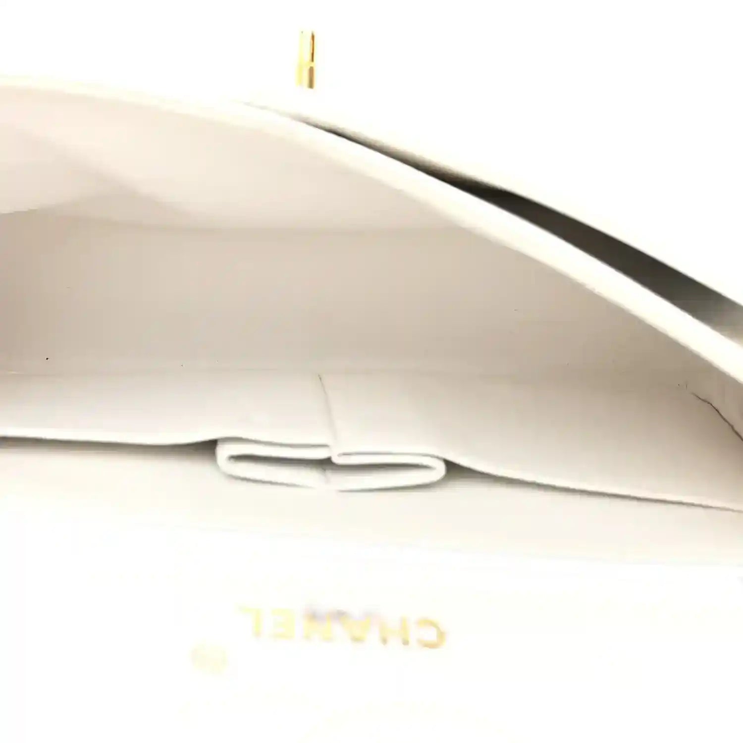 White leather interior lining with stitched pocket and partially visible Chanel branding