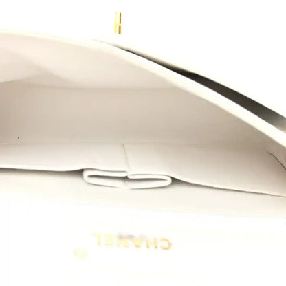 White leather interior lining with stitched pocket and partially visible Chanel branding