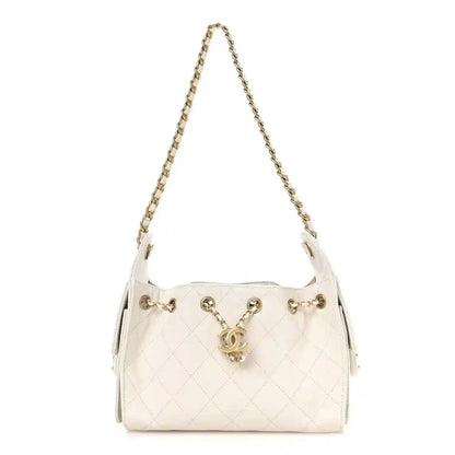 White quilted mini handbag with gold chain strap, front flap and CC clasp.