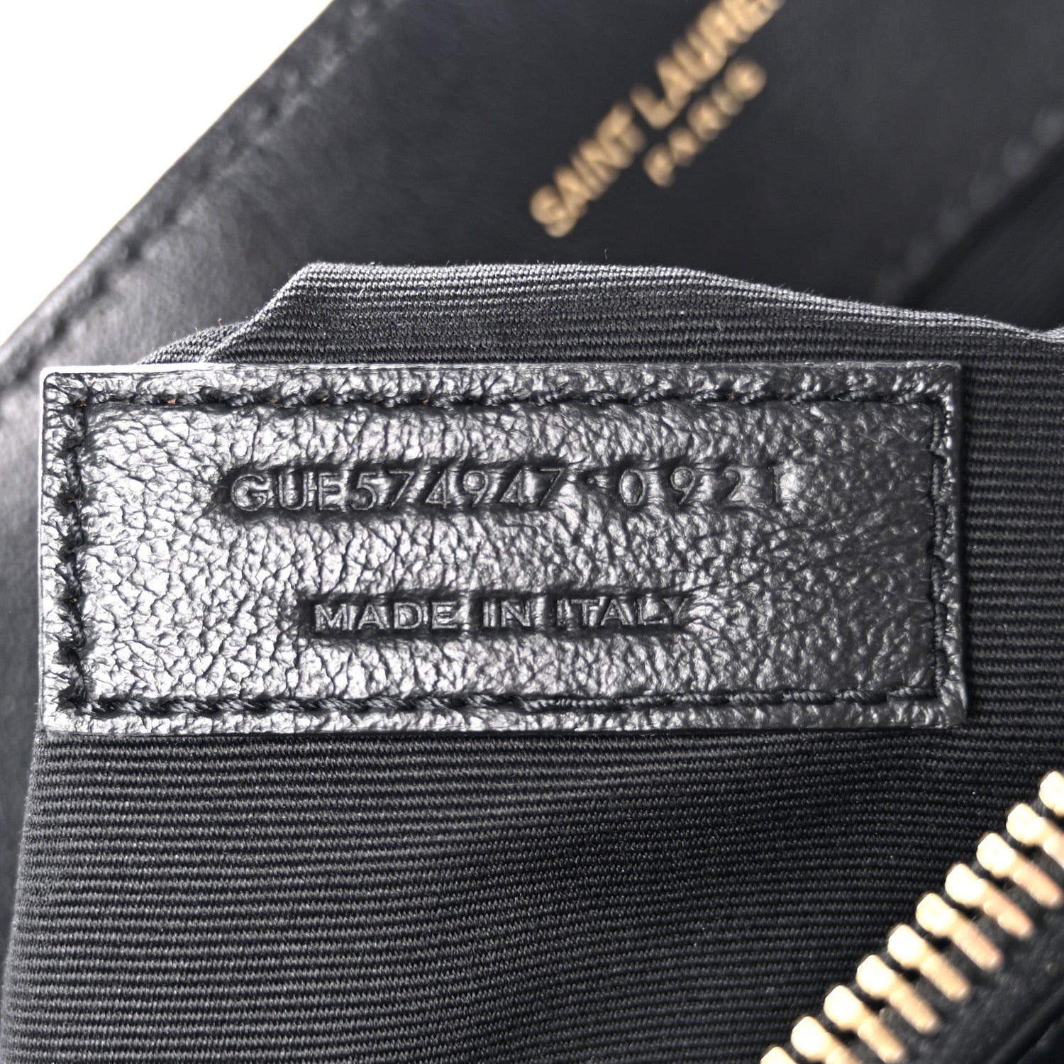 Black satchel interior label with model code and "MADE IN ITALY" text