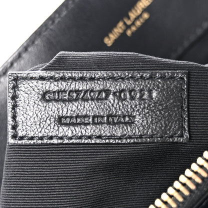Black satchel interior label with model code and "MADE IN ITALY" text