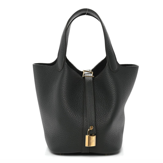 Mini leather tote bag, textured dark green with gold lock closure and top handles.