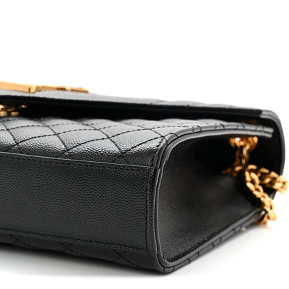 Black quilted satchel bag side view with open top edge and gold chain hardware