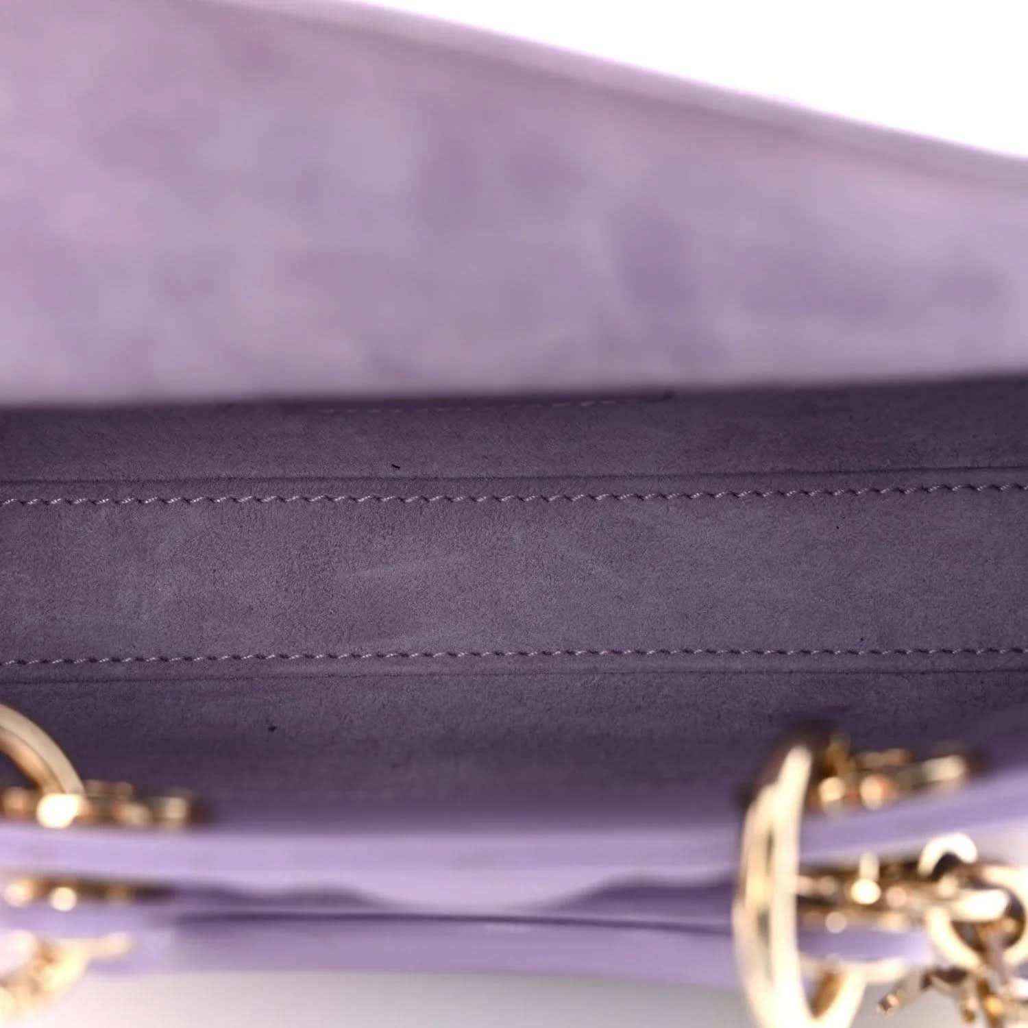 Lilac leather interior panel with stitched edge and gold-tone hardware ring