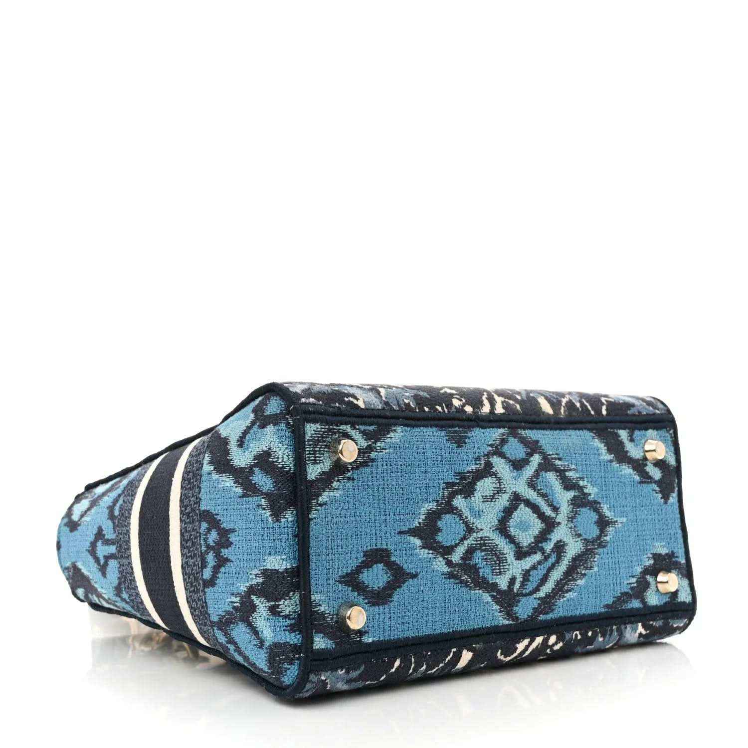Structured bag bottom with blue-and-navy toile print, black piping, and gold stud details
