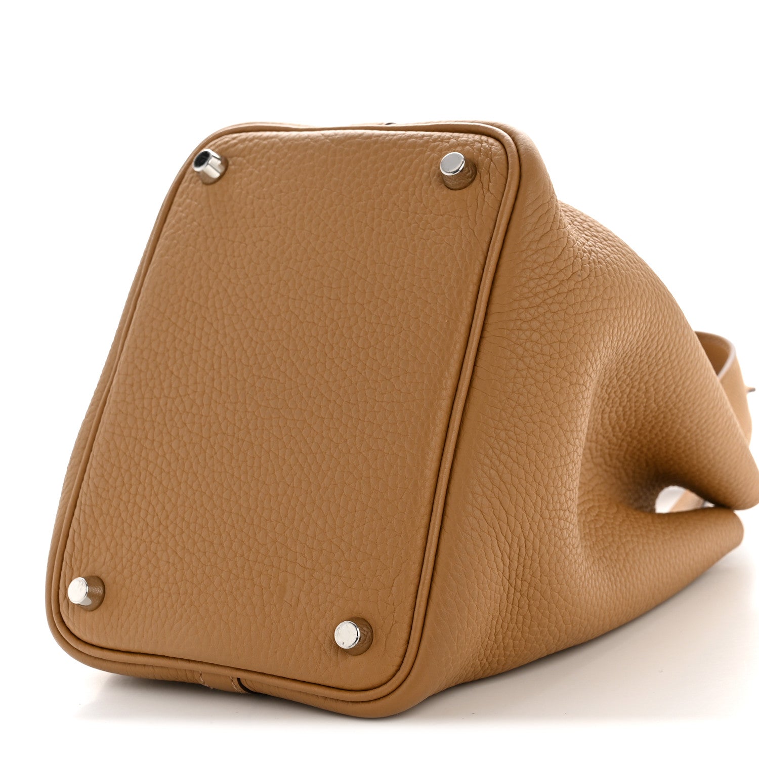 Tan leather bucket bag with corner studs and curved side panel