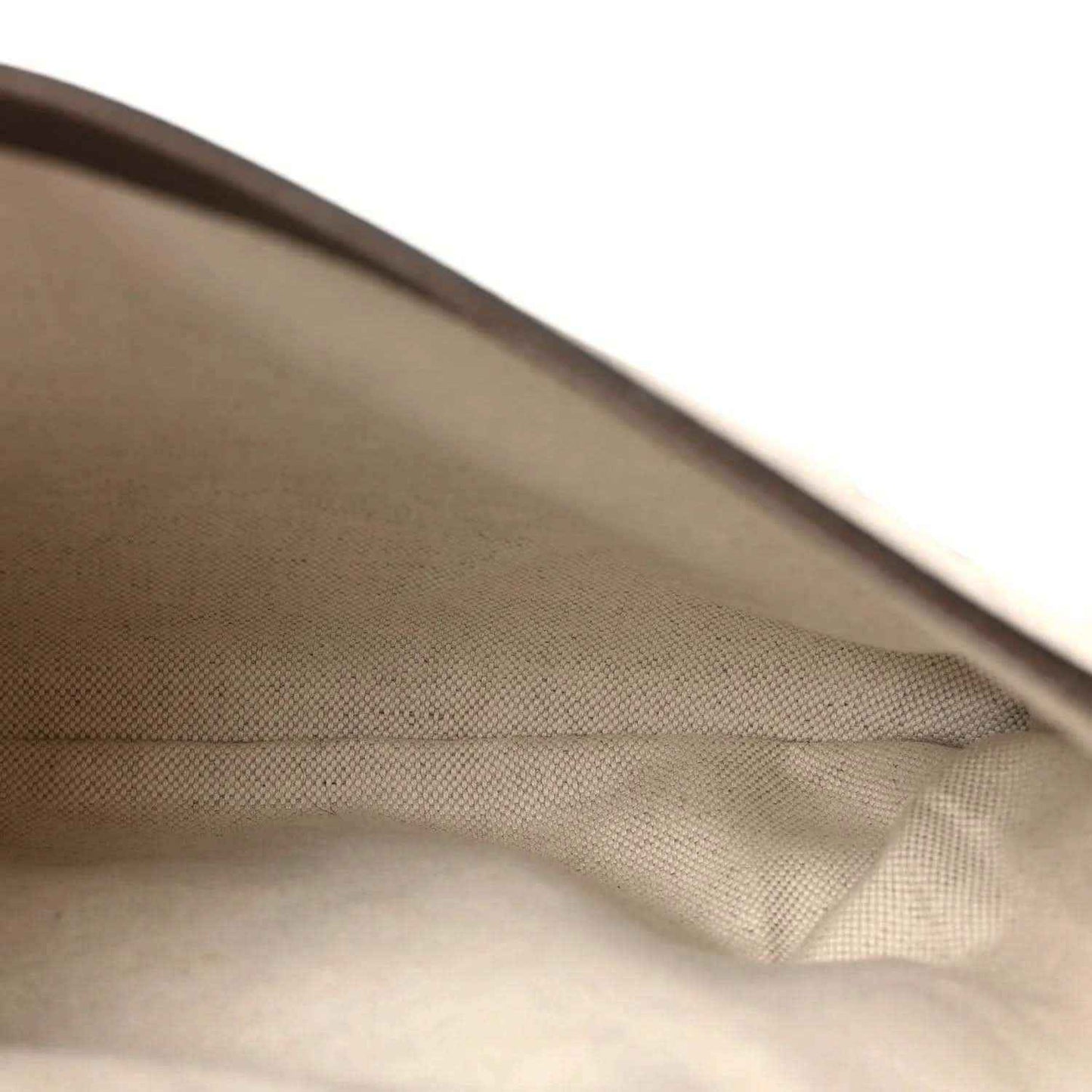 Light tan fabric lining with fold and edge seam inside GG Supreme shoulder bag
