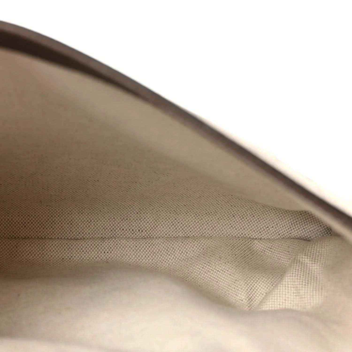 Light tan fabric lining with fold and edge seam inside GG Supreme shoulder bag