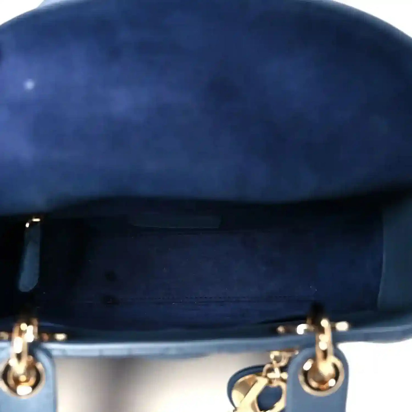 Indigo blue leather handbag top with gold-tone ring hardware and zipper opening