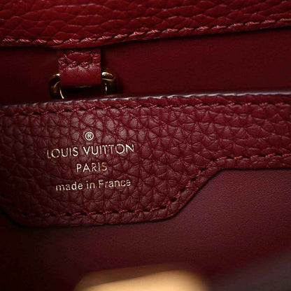 Louis Vuitton Paris leather stamp panel with stitching and strap attachment.