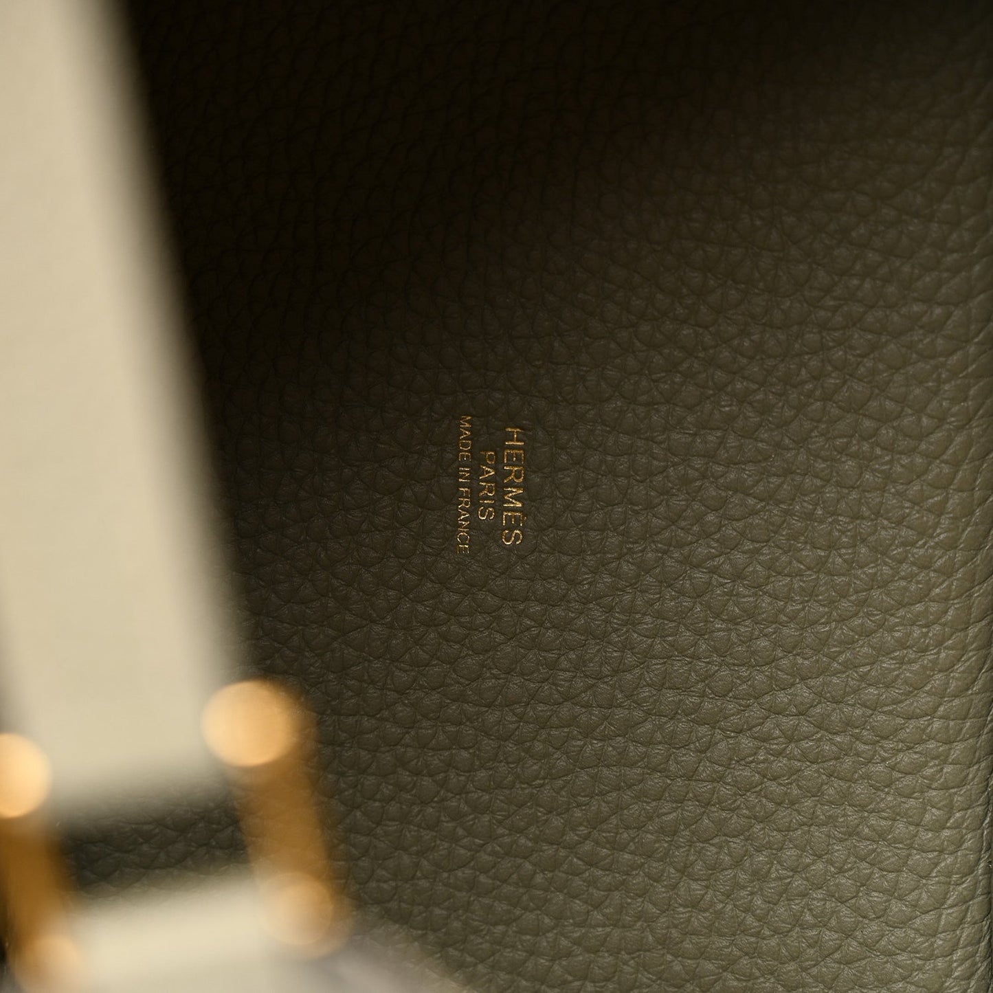 Sauge leather tote bag interior stamp label in tan-gold text