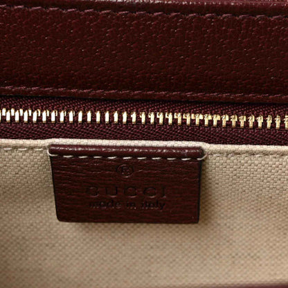 Gucci shoulder bag close-up of interior tag and gold-tone zipper at top edge