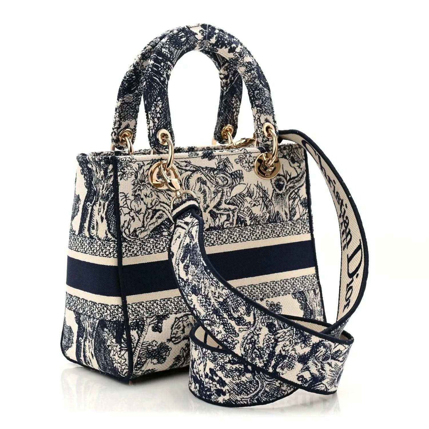 Blue toile de Jouy handbag with top handles, detachable strap, and gold charms.