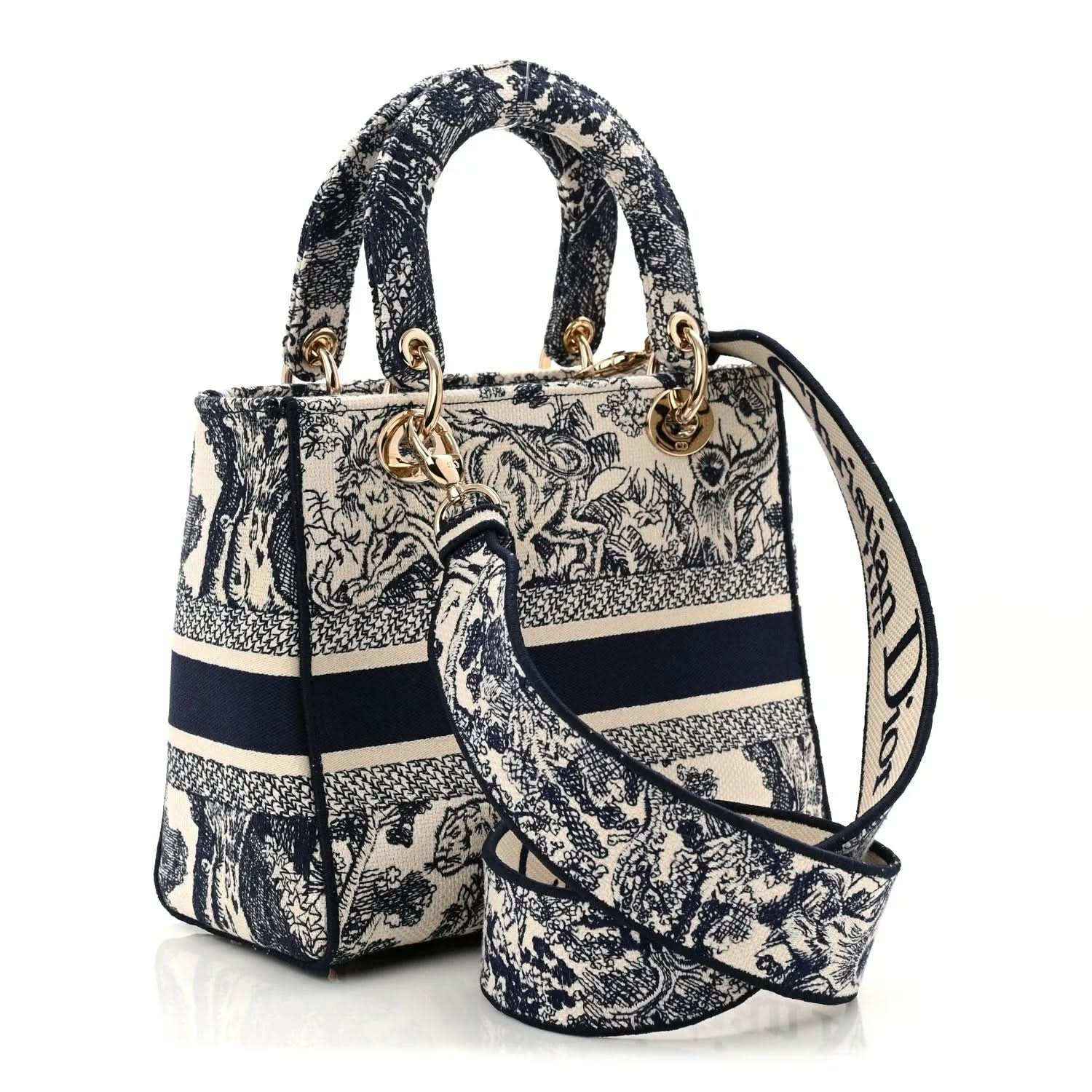 Blue toile de Jouy handbag with top handles, detachable strap, and gold charms.
