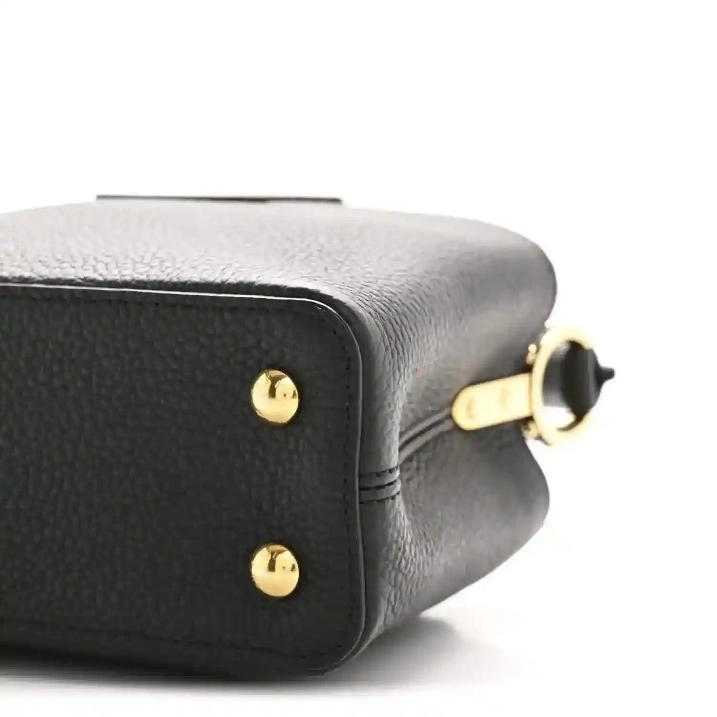 Black leather mini handbag close-up of side panel with gold ring hardware