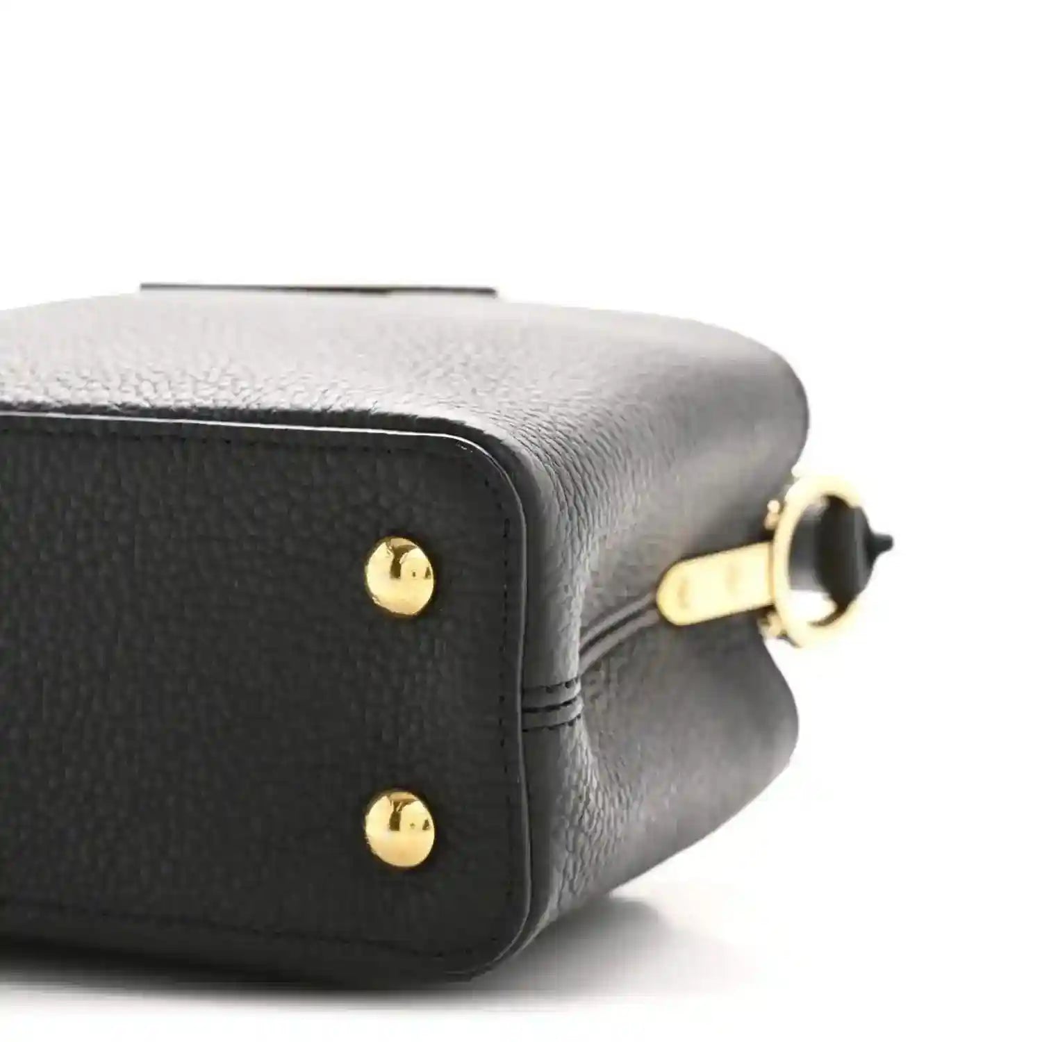 Black leather mini handbag close-up of side panel with gold ring hardware
