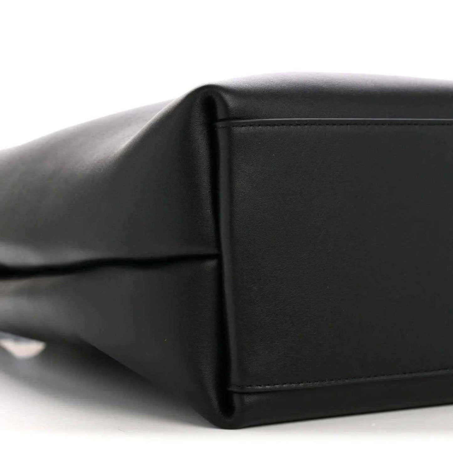 Black bucket bag side panel with seam detail and smooth leather texture