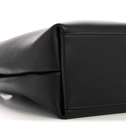 Black bucket bag side panel with seam detail and smooth leather texture