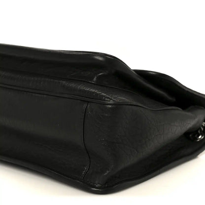 Black grained lambskin satchel with curved flap and metal hardware corner